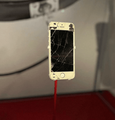 Steve Lacy's broken phone in a case at the Smithsonian Museum.