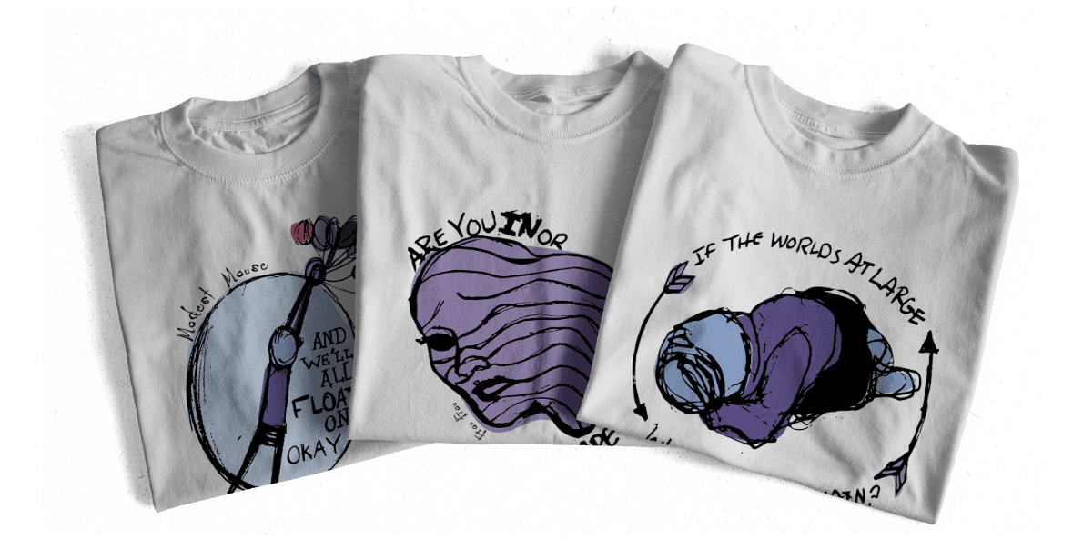 Song lyric shirts folded and displayed next to each other.