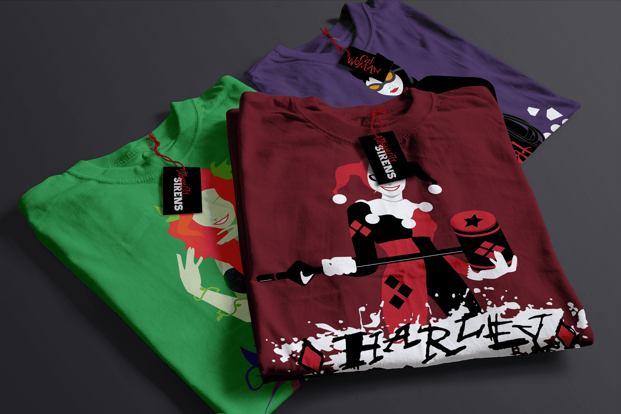 Stack of Gotham City Siren shirts (Harley shirt on top, Poison Ivy shirt on the bottom left, and Catwoman shirt on the bottom right).